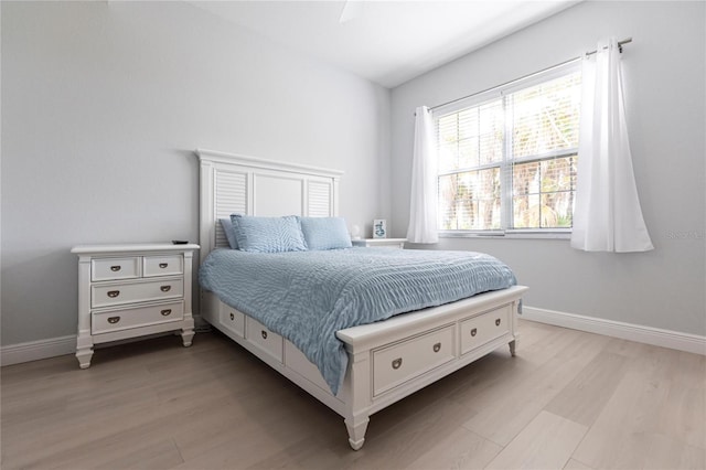 bedroom with ceiling fan and light hardwood / wood-style floors