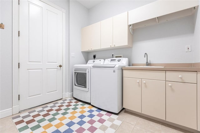 laundry area featuring cabinets, washer and dryer, and sink