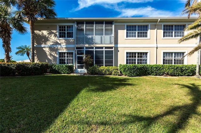 rear view of property with a yard