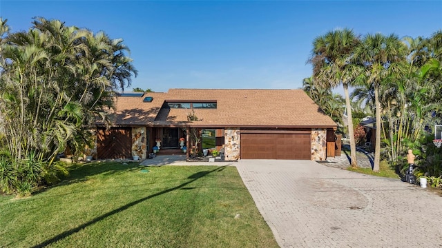 view of front of property featuring a garage and a front yard