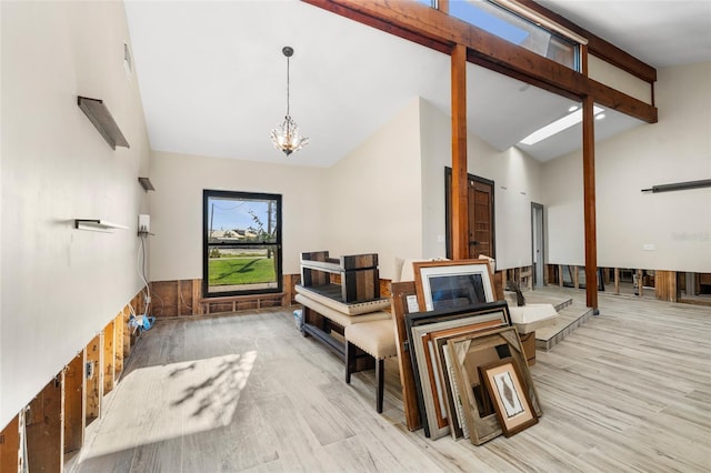 interior space with beamed ceiling, high vaulted ceiling, light hardwood / wood-style flooring, and a notable chandelier