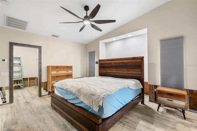 bedroom featuring lofted ceiling, light hardwood / wood-style flooring, and ceiling fan