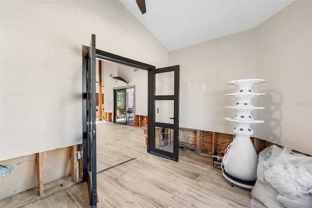 interior space featuring lofted ceiling and light wood-type flooring