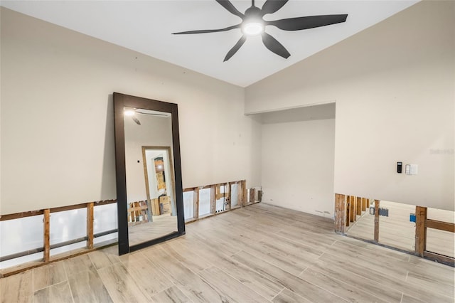 spare room with lofted ceiling, light hardwood / wood-style flooring, and ceiling fan