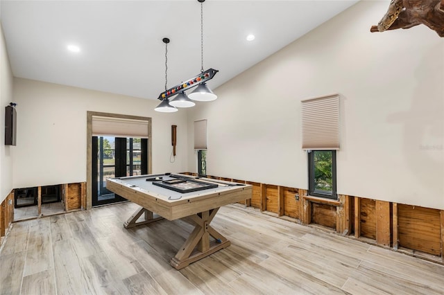 game room with high vaulted ceiling and light wood-type flooring