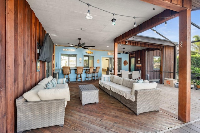 living room featuring ceiling fan and wood-type flooring