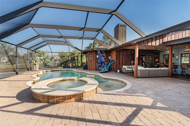 view of pool featuring an in ground hot tub, outdoor lounge area, a patio, and a lanai