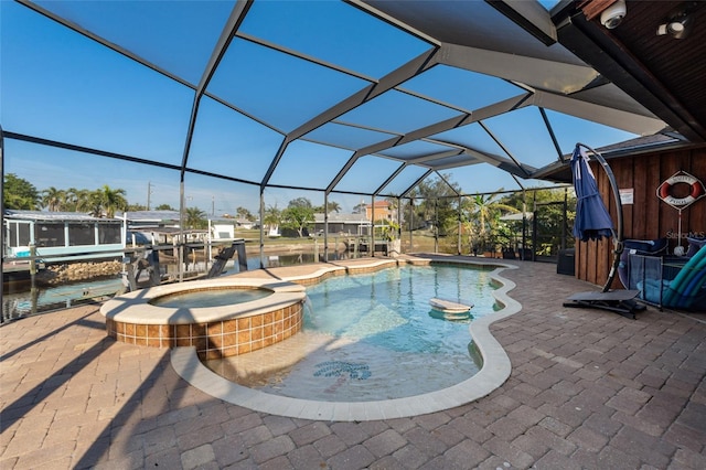 view of swimming pool featuring a lanai, a patio, and an in ground hot tub