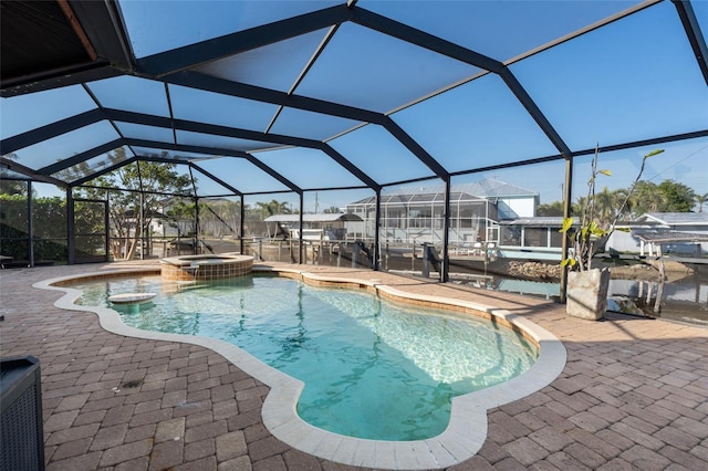 view of pool with an in ground hot tub, a lanai, and a patio area