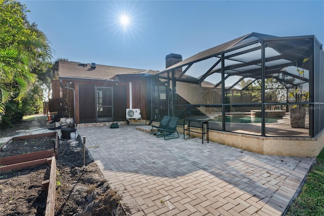 view of patio featuring glass enclosure