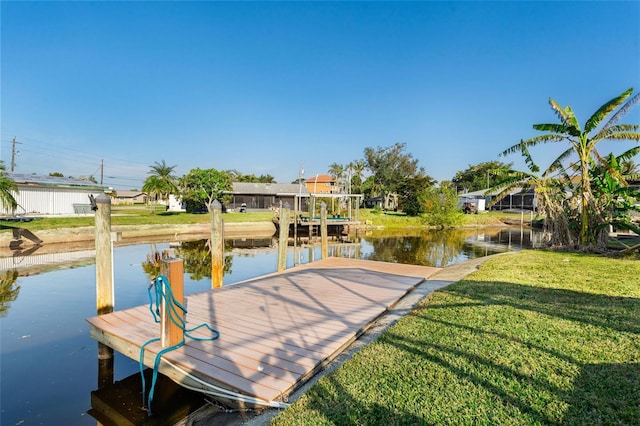 dock area featuring a yard and a water view