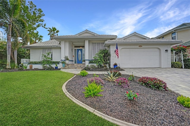 view of front of home with a garage and a front lawn