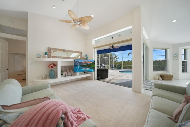 carpeted living room featuring high vaulted ceiling and ceiling fan