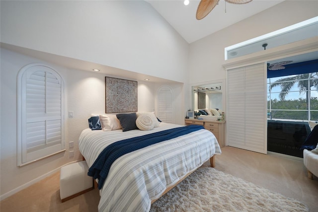 carpeted bedroom featuring access to outside, high vaulted ceiling, and ceiling fan