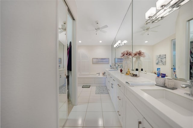 bathroom with ceiling fan, a tub to relax in, tile patterned flooring, and vanity