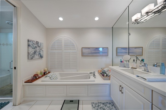 bathroom with vanity, tile patterned floors, and plus walk in shower