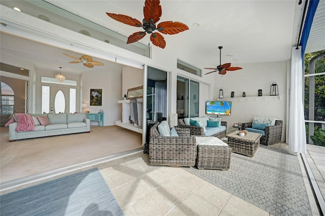 sunroom / solarium featuring ceiling fan