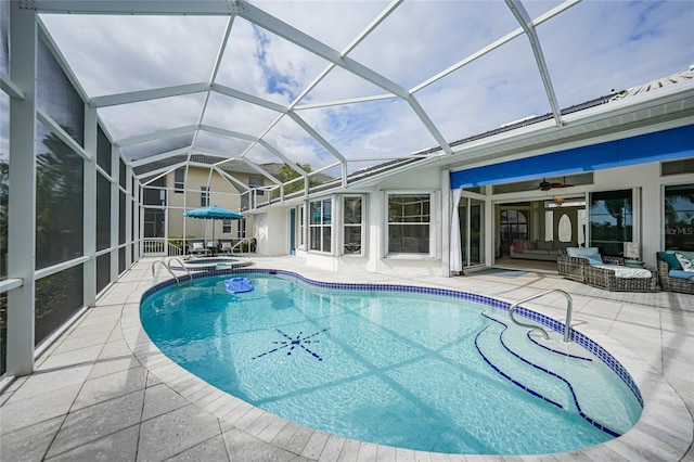 view of pool featuring a lanai, a patio area, outdoor lounge area, and an in ground hot tub