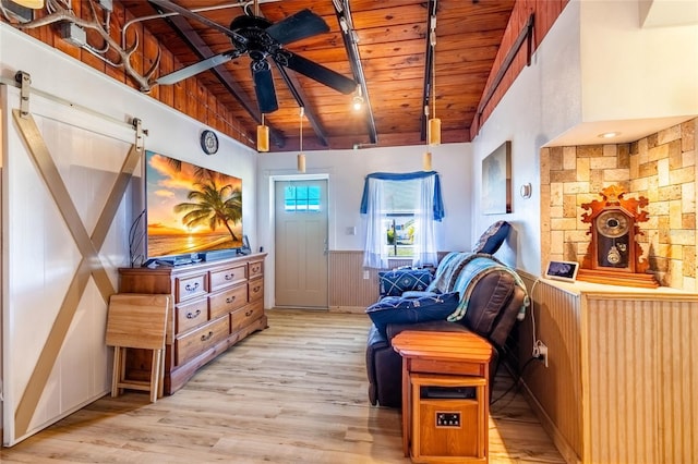 sitting room with wood ceiling, ceiling fan, light hardwood / wood-style floors, and vaulted ceiling with beams