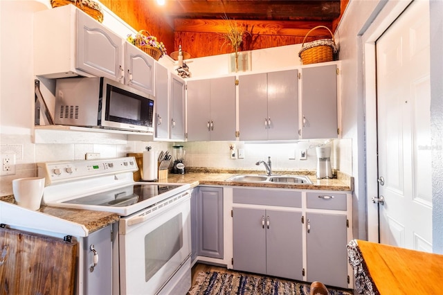 kitchen with white electric range, sink, gray cabinetry, wooden counters, and backsplash