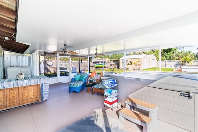 sunroom / solarium featuring ceiling fan and independent washer and dryer