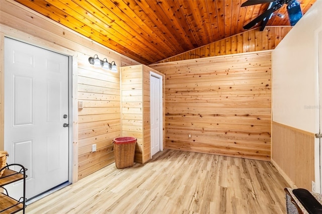 mudroom with vaulted ceiling, light hardwood / wood-style floors, wood ceiling, and wood walls