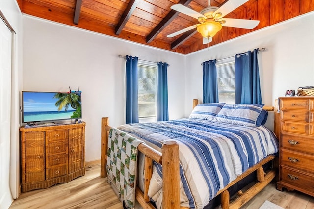 bedroom featuring multiple windows, vaulted ceiling with beams, wood ceiling, and light hardwood / wood-style floors