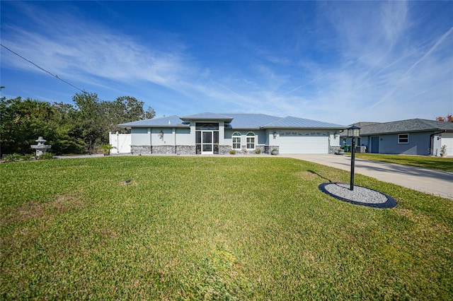 view of front of house featuring a garage and a front lawn