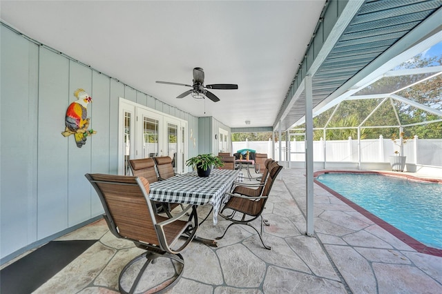 view of patio featuring french doors, ceiling fan, a fenced in pool, and glass enclosure