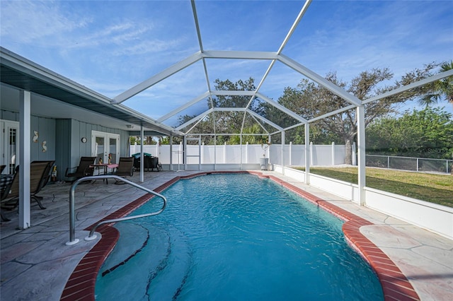 view of pool with a lanai, a patio area, and french doors