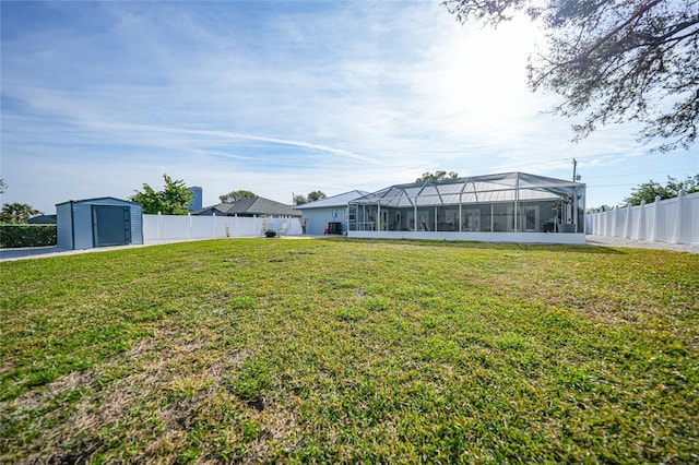 view of yard with a lanai and a storage shed