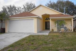 view of front of house with a garage and a front yard