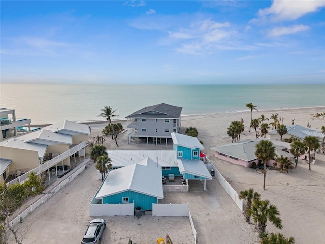 drone / aerial view with a water view and a beach view