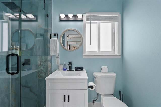 bathroom with vanity, an enclosed shower, and toilet