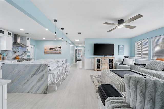 living room featuring ceiling fan and light wood-type flooring