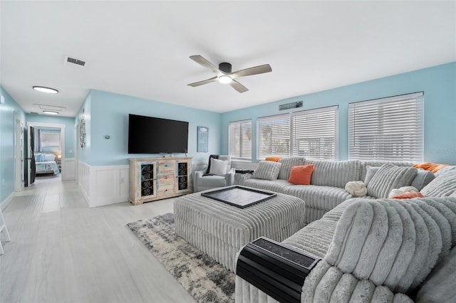 living room with ceiling fan and light wood-type flooring