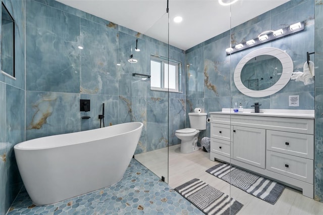 full bathroom featuring vanity, toilet, separate shower and tub, and tile walls