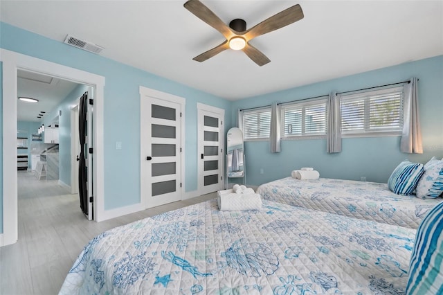 bedroom with light hardwood / wood-style flooring and ceiling fan