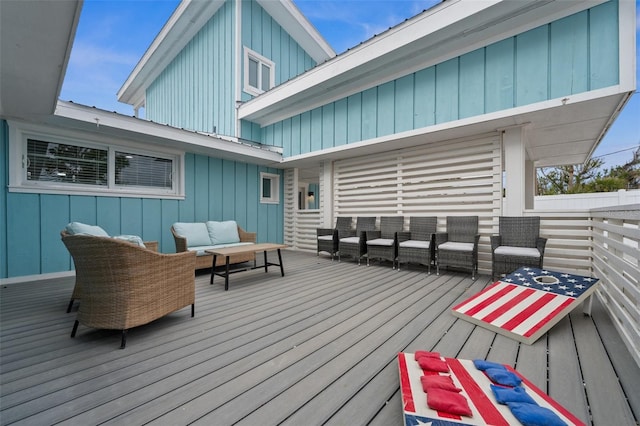 wooden deck with an outdoor living space