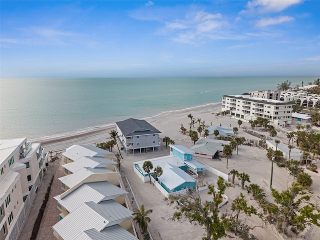 birds eye view of property featuring a water view and a beach view