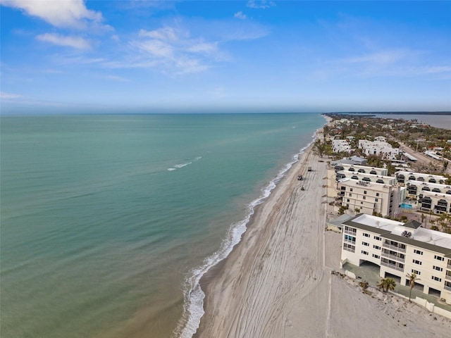 birds eye view of property featuring a water view and a beach view