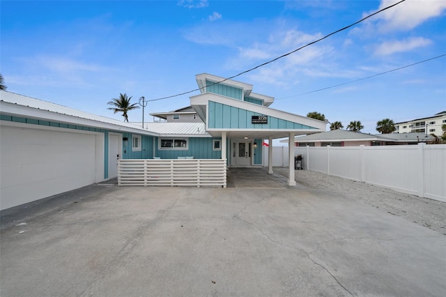 view of front of home with a garage and a carport