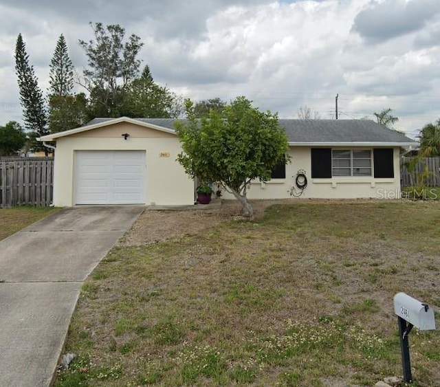 ranch-style home featuring a garage and a front lawn