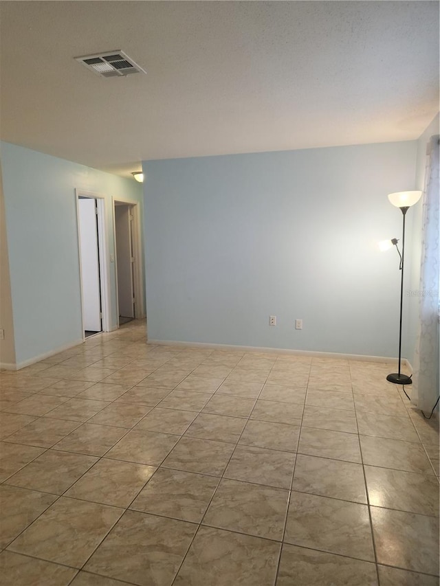 empty room with light tile patterned floors