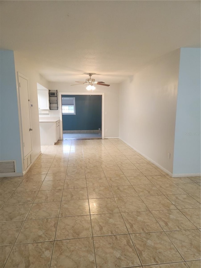 spare room with light tile patterned floors and ceiling fan