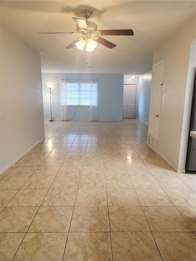 unfurnished room featuring light tile patterned flooring and ceiling fan