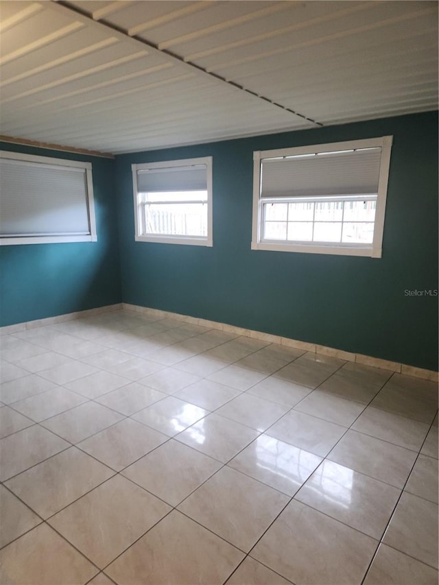 empty room featuring light tile patterned floors and a wealth of natural light