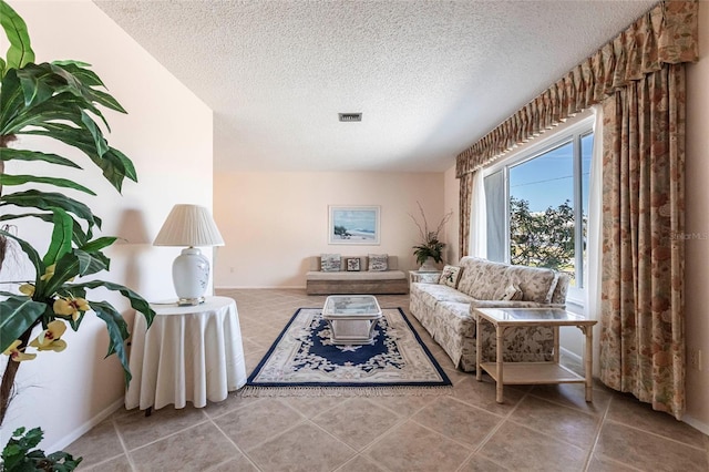 living room featuring tile patterned flooring and a textured ceiling