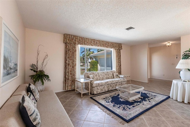 living room with tile patterned flooring and a textured ceiling