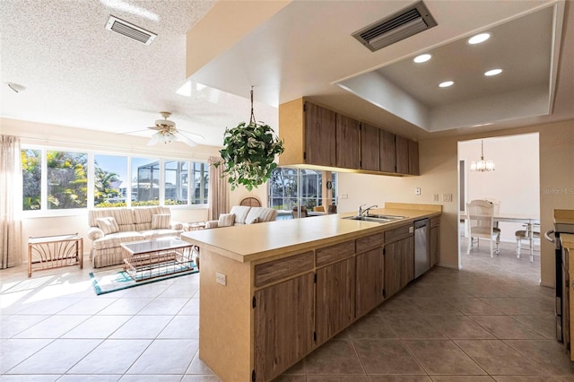 kitchen featuring light tile patterned flooring, kitchen peninsula, and sink